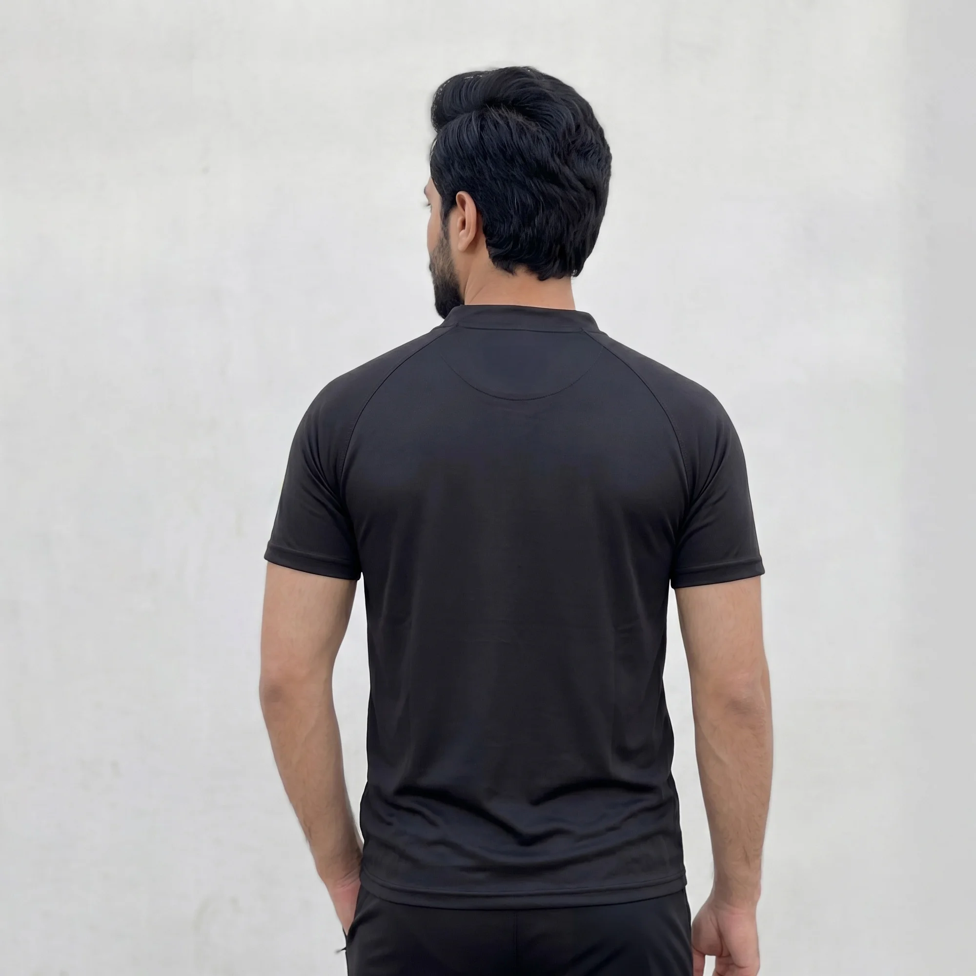 Back view of men's black athletic co-ord set