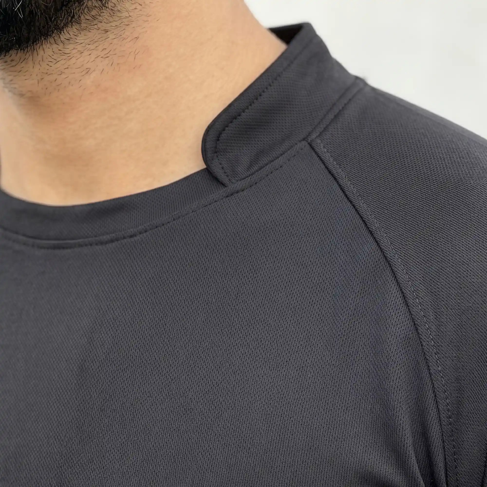 Close-up of black polyester interlock athletic t-shirt collar detail
