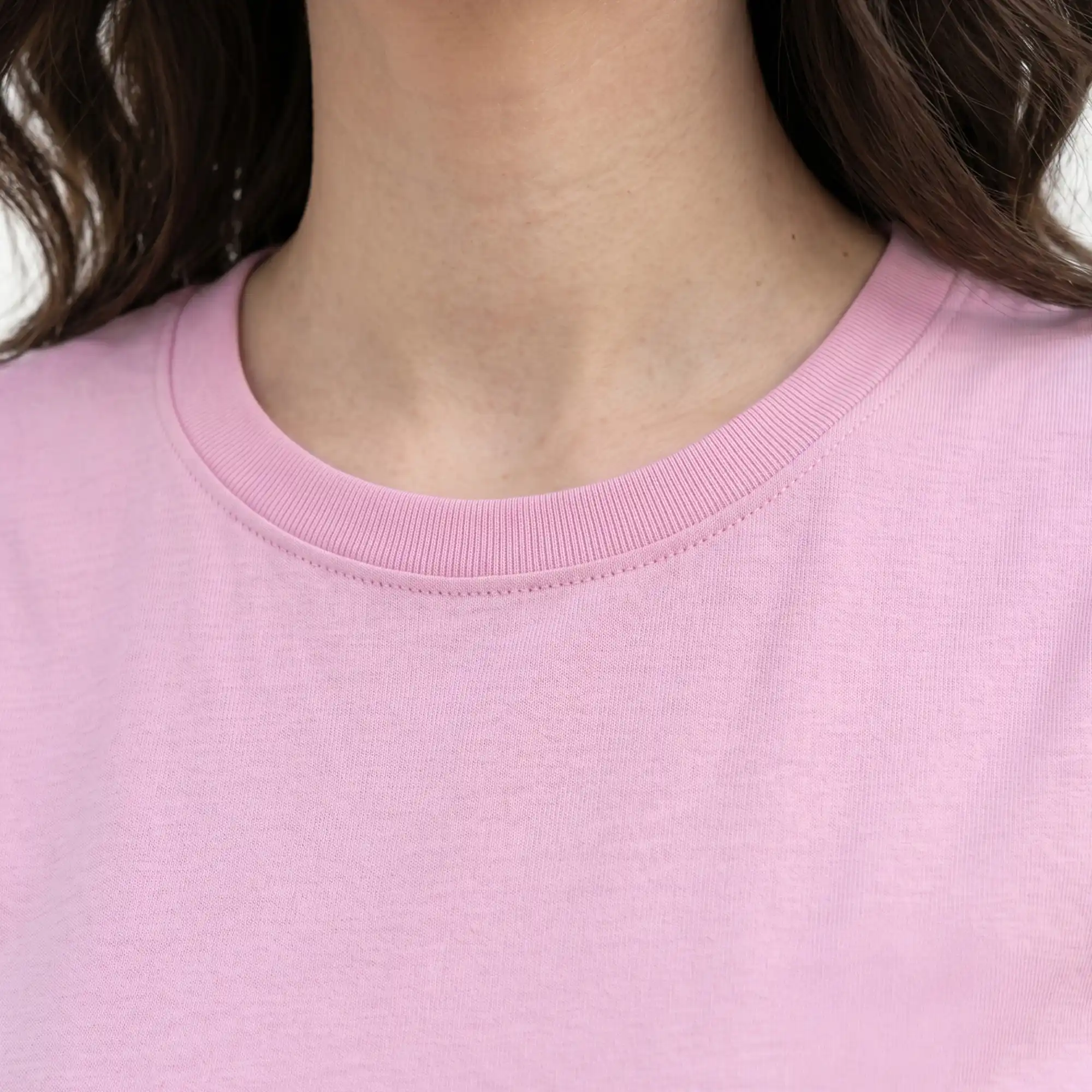 Close-up detail of pink crew neck t-shirt collar