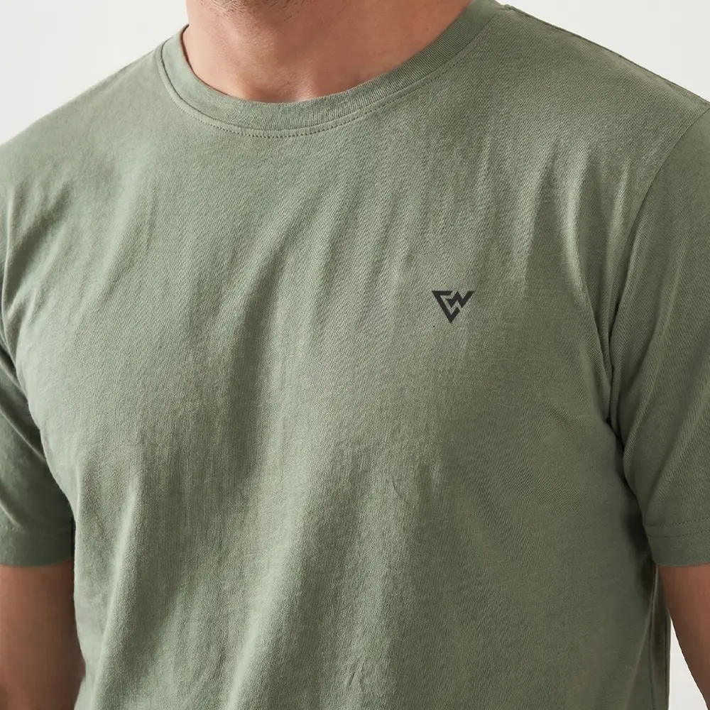 Closeup of men's sage green t shirt fabric and chest logo detail