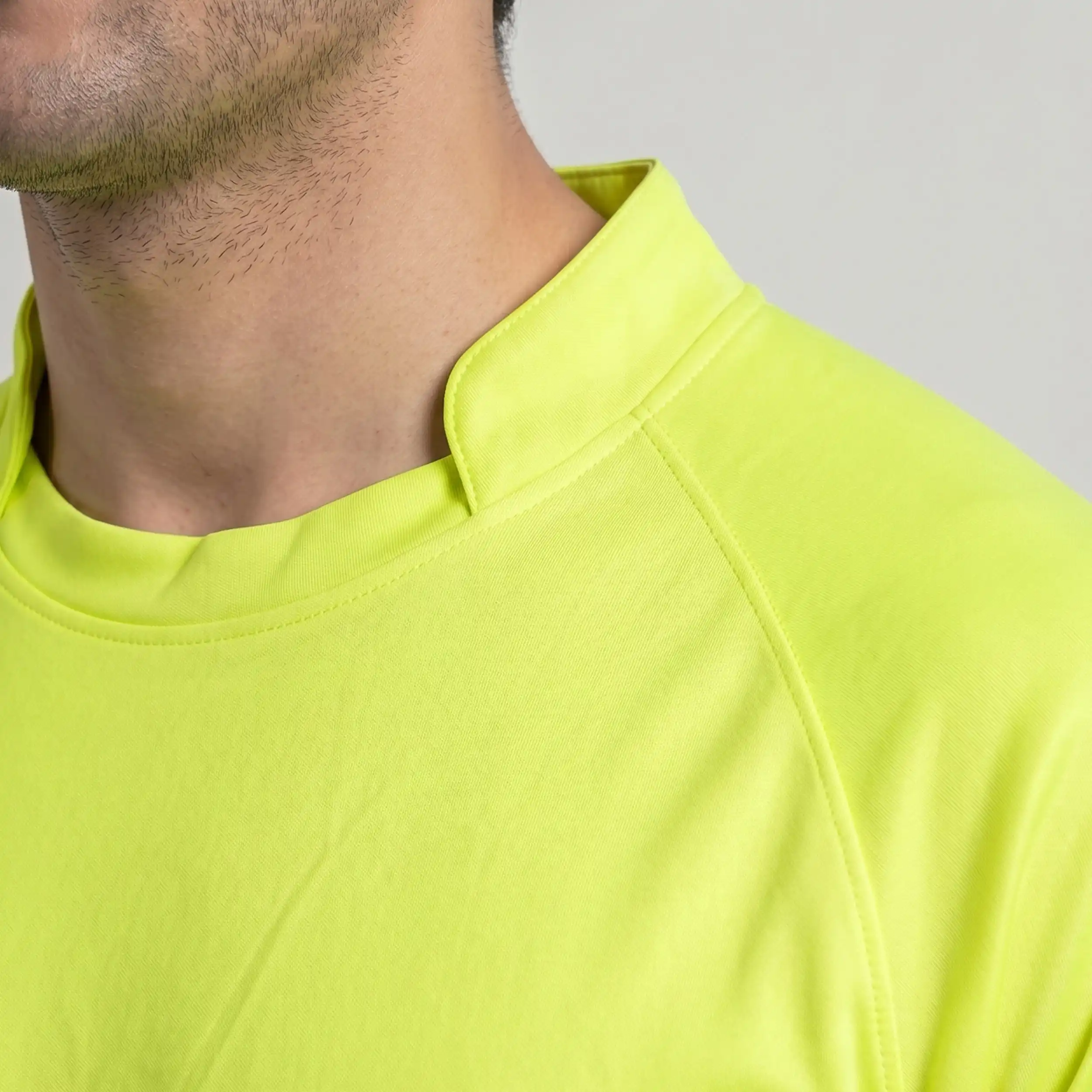 Close-up of neon yellow polyester interlock t-shirt collar detail