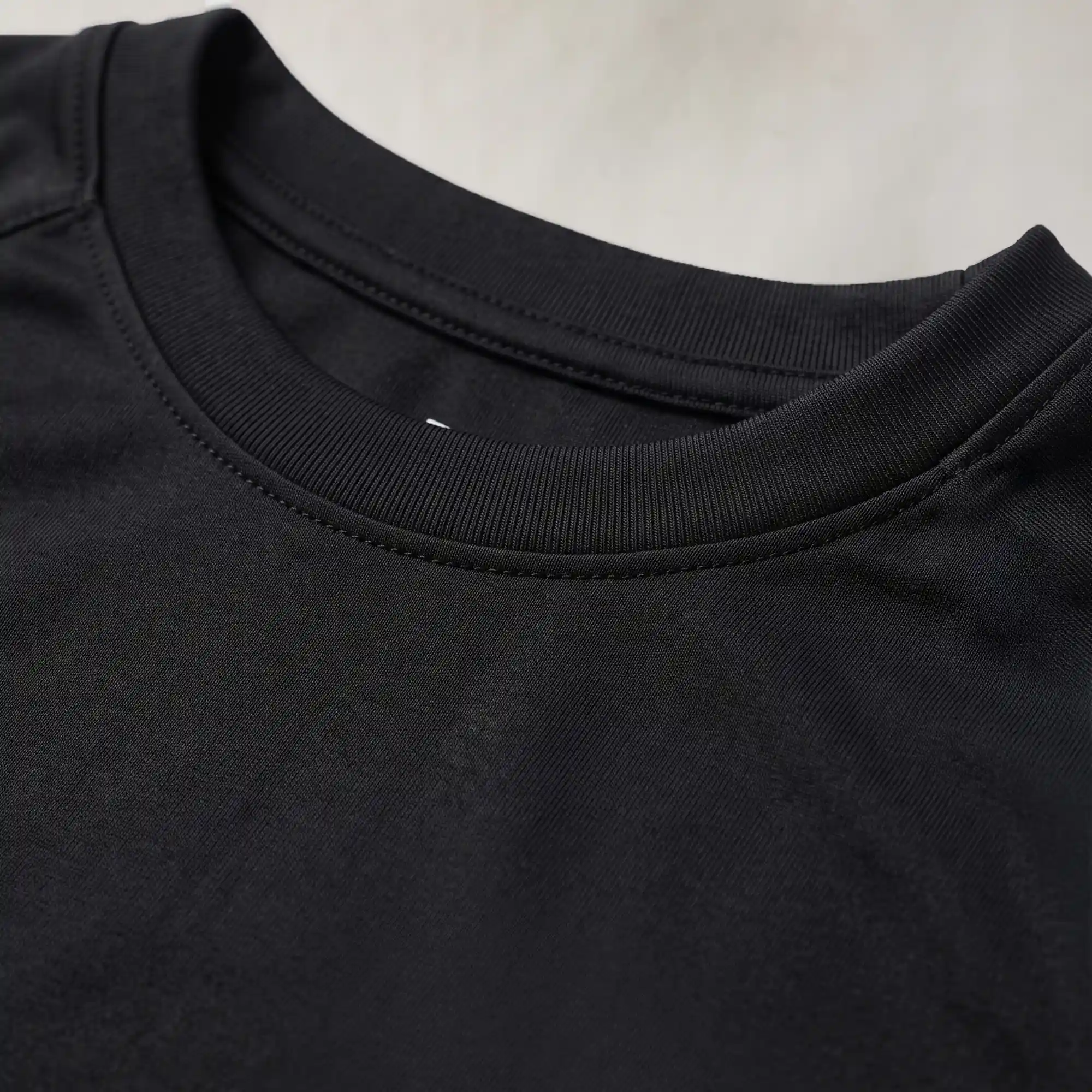 Close-up of women's black round neck t-shirt collar