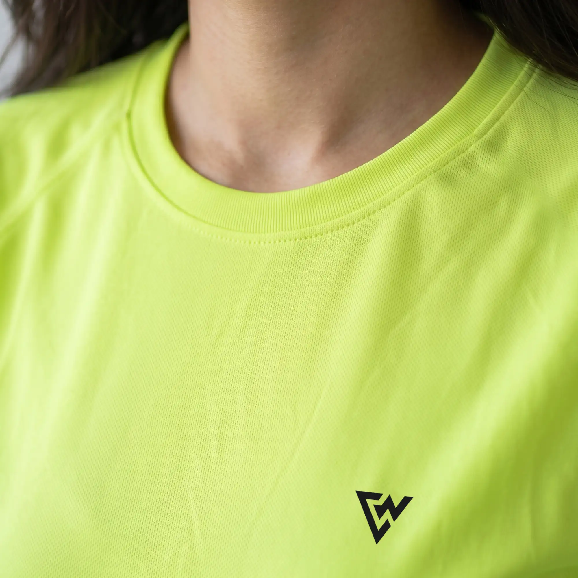 Close-up of women's neon yellow round neck t-shirt collar